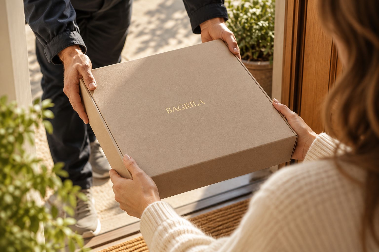 A courier handing the BAGRILA collection box to a customer at her door